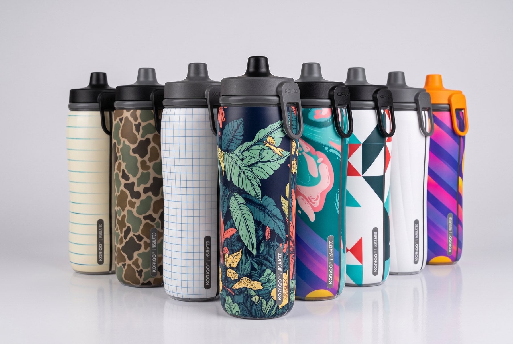 All eight KORIQO full-wrap bottles in a studio lineup — Night Bloom front and center